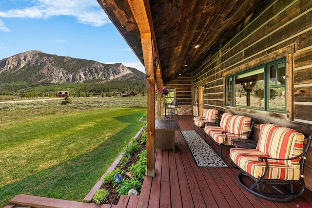322 Wapiti Ln, Crested Butte, CO 81224 - wooden deck with a mountain view, a yard, and an outdoor hangout area