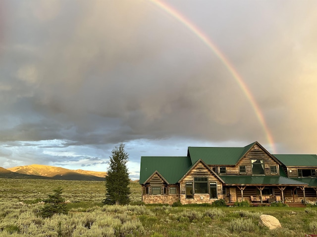322 Wapiti Ln, Crested Butte, CO 81224 - cabin featuring stone siding, a metal roof, and a mountain view