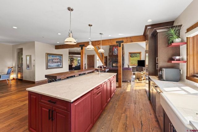 322 Wapiti Ln, Crested Butte, CO 81224 - kitchen with dark wood-style floors, recessed lighting, dark brown cabinets, open floor plan, and decorative light fixtures