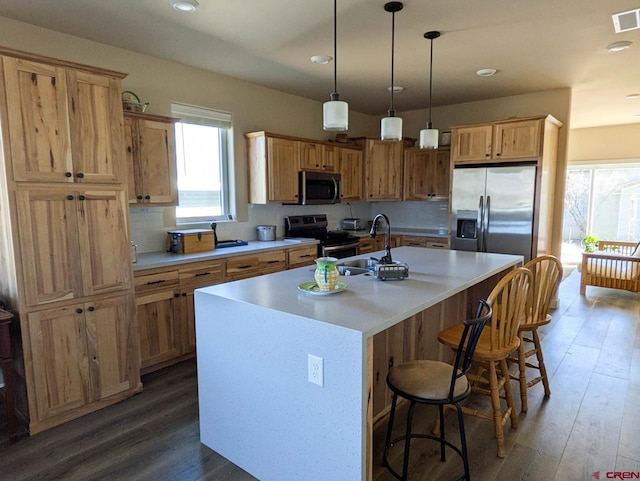 117 N Fork Ave, Paonia, CO 81428 - kitchen featuring appliances with stainless steel finishes, an island with sink, light countertops, recessed lighting, and decorative light fixtures