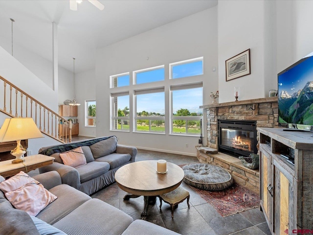 12689 6100th Rd, Montrose, CO 81401 - living area featuring a fireplace, a towering ceiling, stairs, and ceiling fan