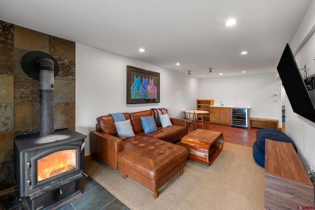 41 Cinnamon Mountain Rd, Mount Crested Butte, CO 81225 - living area with wine cooler, a wood stove, recessed lighting, and bar area