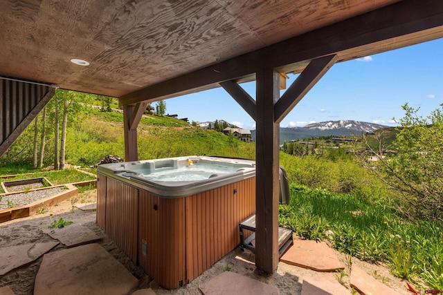 41 Cinnamon Mountain Rd, Mount Crested Butte, CO 81225 - view of patio featuring a hot tub, a mountain view, and a garden
