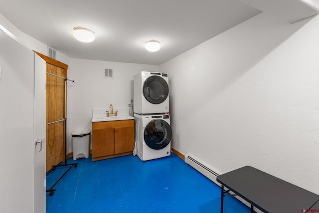 41 Cinnamon Mountain Rd, Mount Crested Butte, CO 81225 - washroom featuring stacked washer / dryer, baseboard heating, and cabinet space