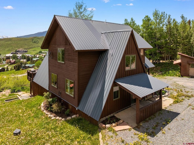 41 Cinnamon Mountain Rd, Mount Crested Butte, CO 81225 - view of property exterior featuring a metal roof, board and batten siding, and a mountain view