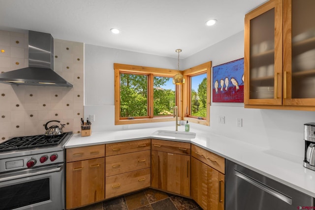 41 Cinnamon Mountain Rd, Mount Crested Butte, CO 81225 - kitchen featuring wall chimney exhaust hood, appliances with stainless steel finishes, brown cabinets, light countertops, and recessed lighting