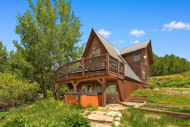 41 Cinnamon Mountain Rd, Mount Crested Butte, CO 81225 - rear view of property with a hot tub, a wooden deck, and a metal roof
