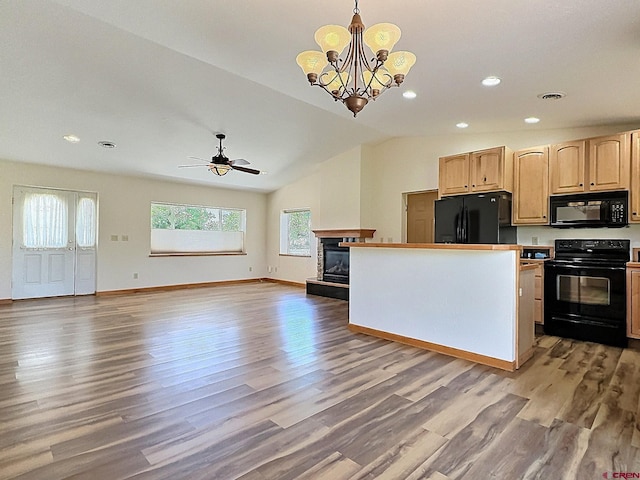 404 SE Birdie Cir, Cedaredge, CO 81413 - kitchen with black appliances, light brown cabinetry, light wood-style flooring, lofted ceiling, and open floor plan