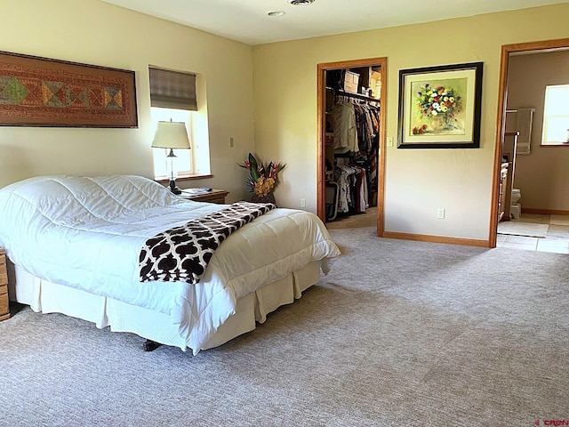 404 SE Birdie Cir, Cedaredge, CO 81413 - bedroom featuring a walk in closet, carpet flooring, a closet, and connected bathroom