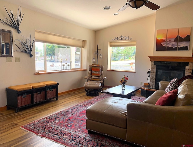 404 SE Birdie Cir, Cedaredge, CO 81413 - living area featuring wood finished floors, ceiling fan, and a stone fireplace