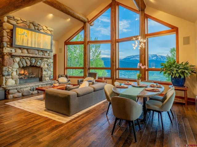 3 Summit Ct, Mount Crested Butte, CO 81225 - dining space with hardwood / wood-style floors, beamed ceiling, a fireplace, a mountain view, and high vaulted ceiling