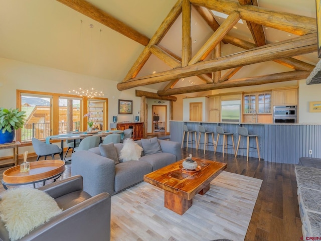 3 Summit Ct, Mount Crested Butte, CO 81225 - living room with high vaulted ceiling, wood finished floors, beamed ceiling, a wainscoted wall, and a chandelier