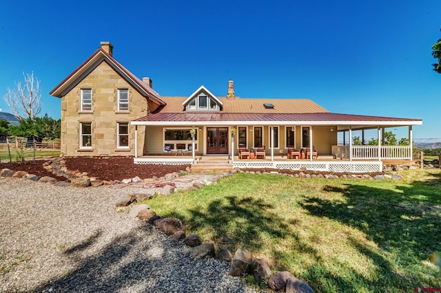 9359 49 1/4 Rd, Mesa, CO 81643 - back of house with covered porch, a lawn, a chimney, a metal roof, and a standing seam roof