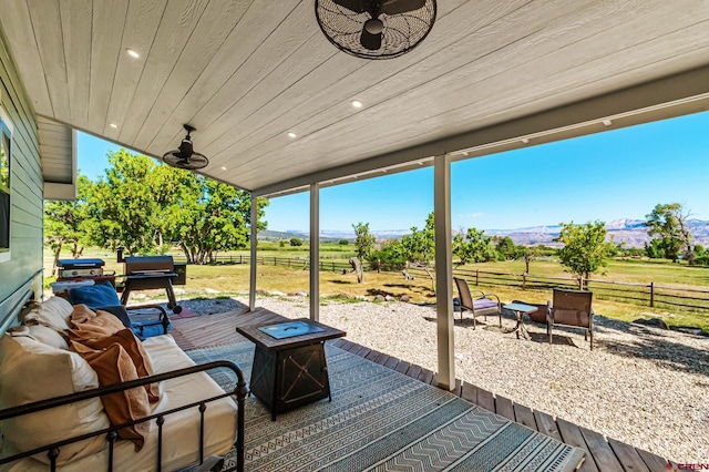 9359 49 1/4 Rd, Mesa, CO 81643 - deck with a rural view, ceiling fan, an outdoor living space with a fire pit, and a mountain view