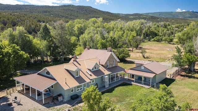 9359 49 1/4 Rd, Mesa, CO 81643 - aerial view of property and surrounding area with a forest and a mountain backdrop
