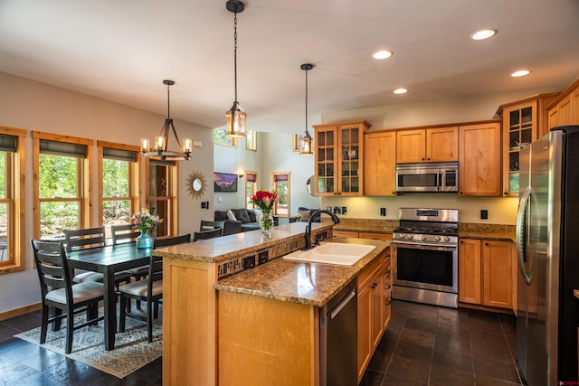 15 Edgemont Way, Durango, CO 81301 - kitchen with stainless steel appliances, recessed lighting, a center island with sink, a chandelier, and brown cabinetry
