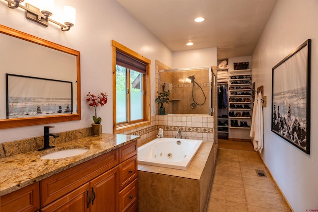 15 Edgemont Way, Durango, CO 81301 - full bathroom with a stall shower, vanity, a whirlpool tub, tile patterned flooring, and a walk in closet
