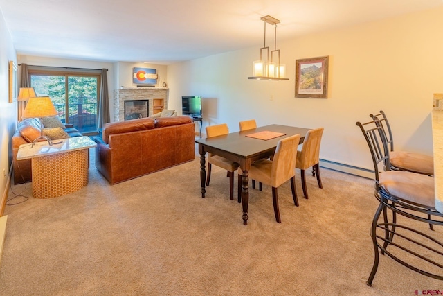 20 Hunter Hill Rd Unit 110, Mount Crested Butte, CO 81225 - dining area with baseboard heating, a fireplace, and light carpet