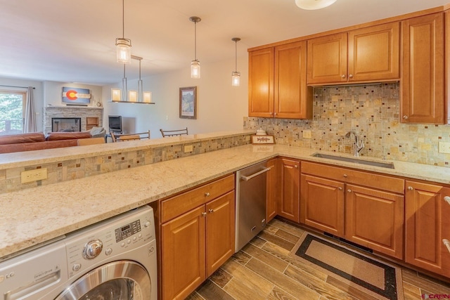 20 Hunter Hill Rd Unit 110, Mount Crested Butte, CO 81225 - kitchen with washer / clothes dryer, stainless steel dishwasher, dark wood finished floors, decorative backsplash, and light stone countertops