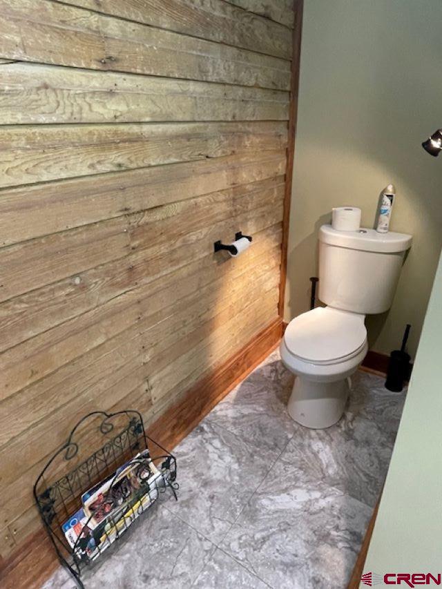 115 S Linden, Cortez, CO 81321 - bathroom with wooden walls and toilet