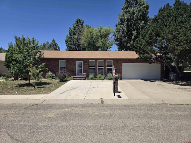 613 N Colorado St, Cortez, CO 81321 - ranch-style home with a garage, brick siding, and driveway