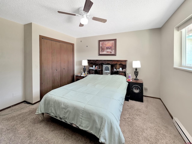 613 N Colorado St, Cortez, CO 81321 - bedroom featuring baseboard heating, carpet flooring, a closet, a textured ceiling, and ceiling fan