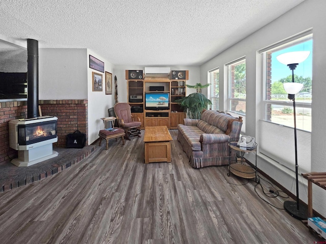 613 N Colorado St, Cortez, CO 81321 - living room with wood finished floors, a textured ceiling, a wood stove, and a wall unit AC