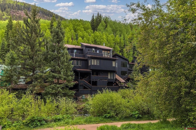 333 S Fir St Unit 101, Telluride, CO 81435 - back of house with a balcony, stairway, a view of trees, and a metal roof