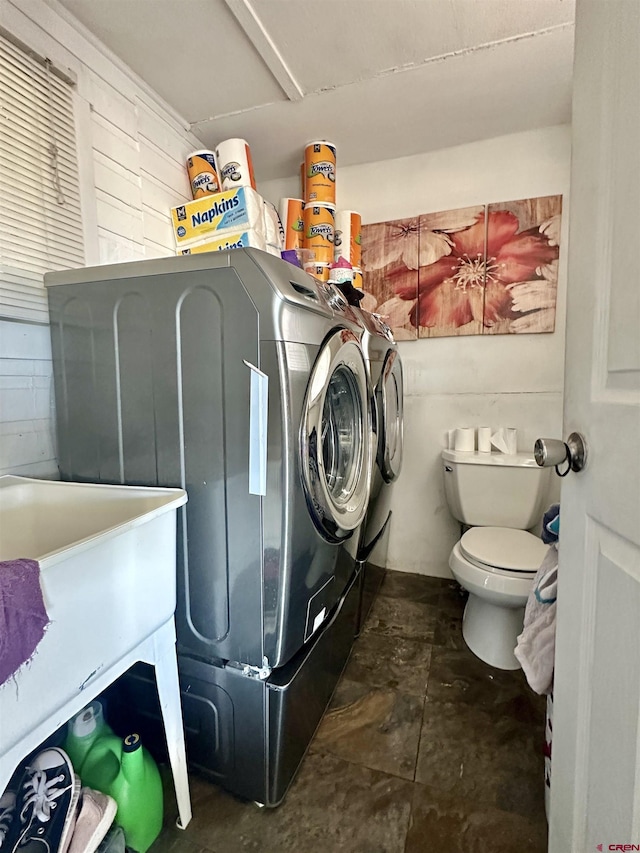 18551 F Rd, Delta, CO 81416 - washroom featuring separate washer and dryer and dark stone finish floors