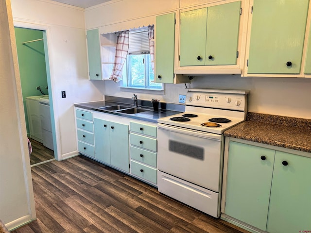 20114 Austin Rd, Austin, CO 81410 - kitchen with white range with electric cooktop, separate washer and dryer, dark wood-style floors, under cabinet range hood, and dark countertops