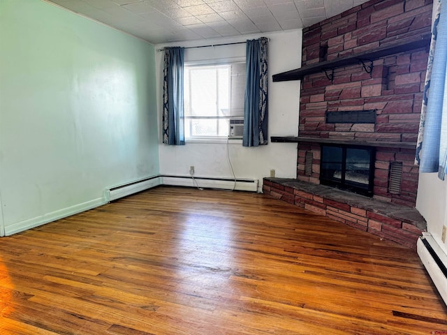 20114 Austin Rd, Austin, CO 81410 - unfurnished living room featuring wood finished floors, baseboard heating, a fireplace, and a baseboard radiator