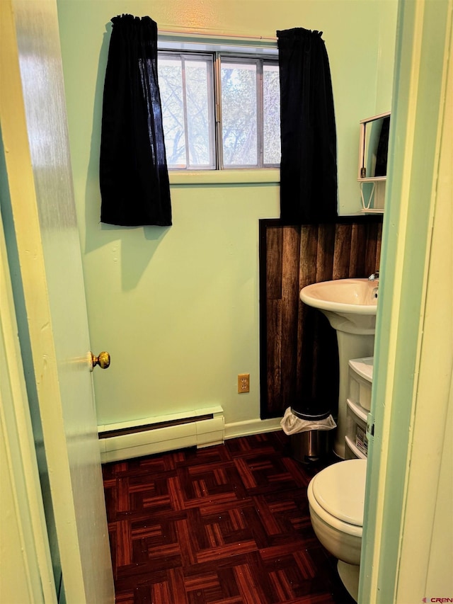 20114 Austin Rd, Austin, CO 81410 - half bathroom featuring a baseboard heating unit and toilet