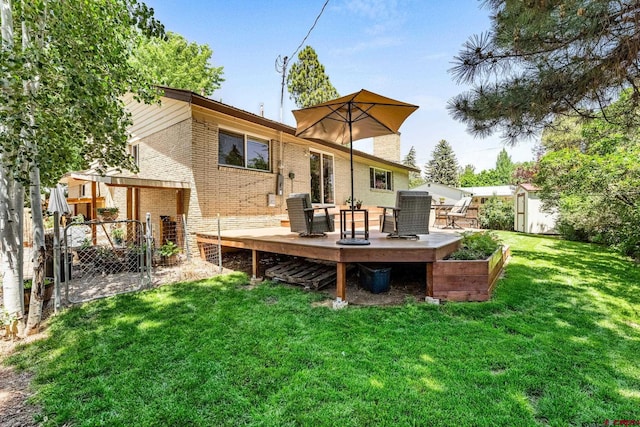 1736 Forest Ave, Durango, CO 81301 - back of house featuring brick siding, a deck, a gate, and a storage shed