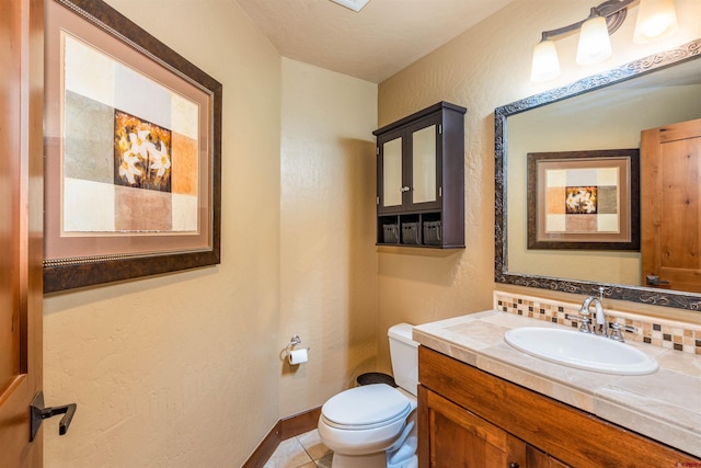 24 Sheol St Unit 202, Durango, CO 81301 - half bath featuring vanity, tile patterned floors, and backsplash