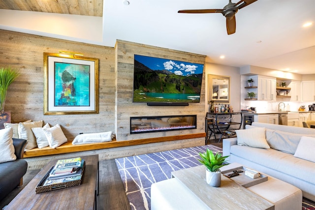 928 Twin Buttes Ave, Durango, CO 81301 - living room with a glass covered fireplace, a ceiling fan, wood finished floors, wooden walls, and recessed lighting