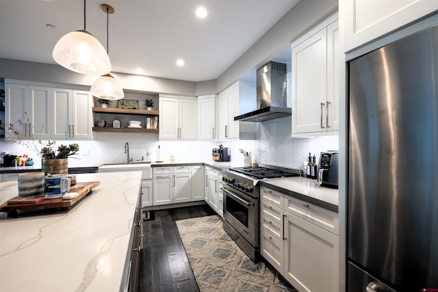 928 Twin Buttes Ave, Durango, CO 81301 - kitchen featuring stainless steel appliances, wall chimney exhaust hood, open shelves, dark wood-style floors, and white cabinetry