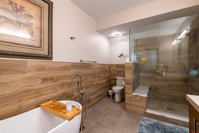 928 Twin Buttes Ave, Durango, CO 81301 - full bath with tile walls, a soaking tub, a shower stall, a wainscoted wall, and tile patterned floors