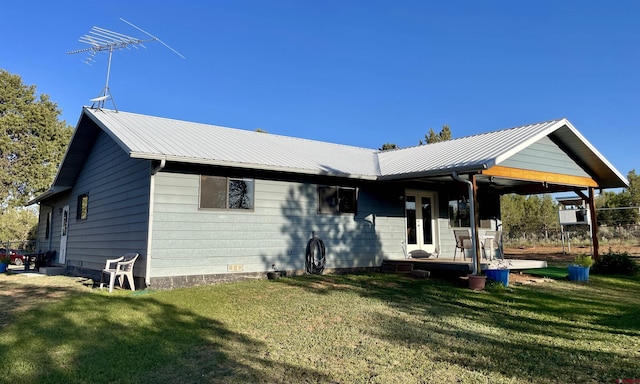 14245 Rd 21, Cortez, CO 81321 - back of house featuring crawl space, a lawn, and a metal roof