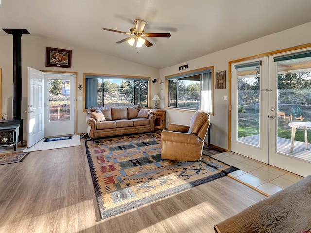 14245 Rd 21, Cortez, CO 81321 - living room featuring a wood stove, french doors, lofted ceiling, and healthy amount of natural light