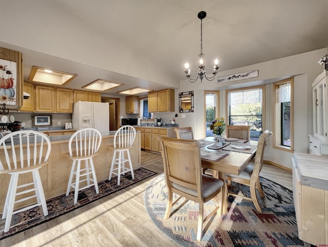 14245 Rd 21, Cortez, CO 81321 - dining room featuring a chandelier, light wood-style flooring, and vaulted ceiling