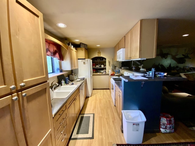 274 Tobin Ln, Gunnison, CO 81230 - kitchen with white appliances, light wood-style floors, recessed lighting, dark countertops, and a peninsula