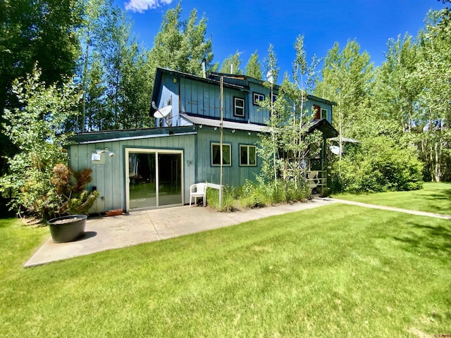 274 Tobin Ln, Gunnison, CO 81230 - back of property with a lawn and a patio