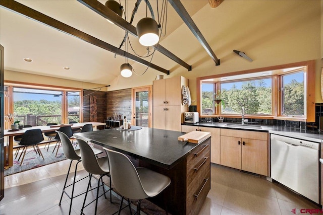 122 Juniper Rd, Ridgway, CO 81432 - kitchen featuring dishwasher, light brown cabinets, dark countertops, beamed ceiling, and a breakfast bar area