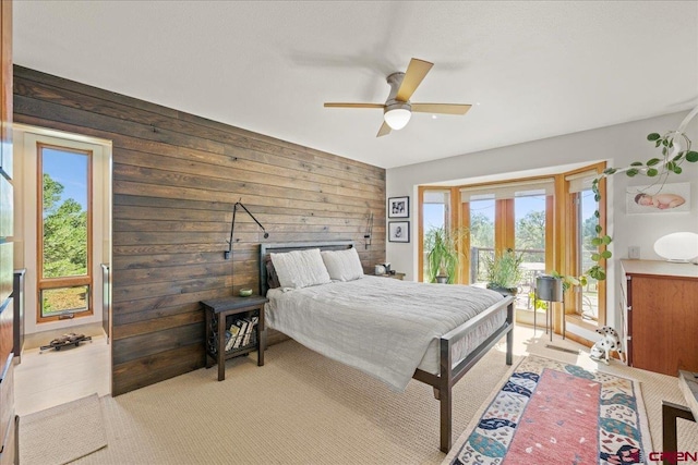 122 Juniper Rd, Ridgway, CO 81432 - bedroom with multiple windows, access to exterior, wood walls, light colored carpet, and french doors