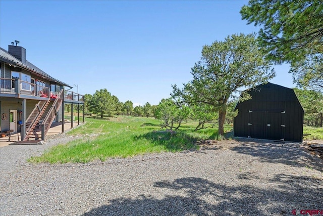 122 Juniper Rd, Ridgway, CO 81432 - view of yard with a shed, a wooden deck, and stairway