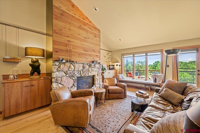 122 Juniper Rd, Ridgway, CO 81432 - living room featuring light wood-type flooring, healthy amount of natural light, high vaulted ceiling, and a stone fireplace
