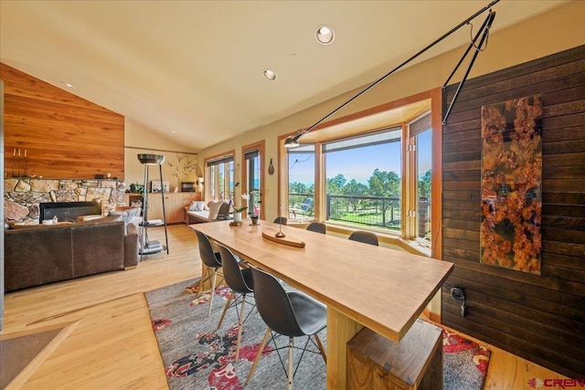 122 Juniper Rd, Ridgway, CO 81432 - dining area with vaulted ceiling, wood finished floors, recessed lighting, a stone fireplace, and wooden walls