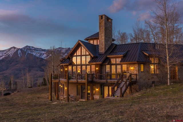 404 Benchmark Dr, Mountain Village, CO 81435 - rear view of house featuring a standing seam roof, a metal roof, a chimney, stairway, and a deck with mountain view