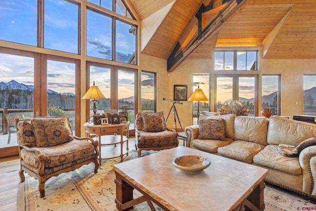 404 Benchmark Dr, Mountain Village, CO 81435 - living room with high vaulted ceiling, a wooden ceiling with exposed beams, a mountain view, wood finished floors, and french doors