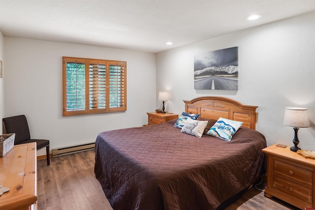 50827 N 550th Hwy Unit 329, Durango, CO 81301 - bedroom with a baseboard heating unit, wood finished floors, and recessed lighting